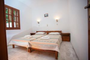 a bedroom with a bed with two towels on it at SINI Apartments 3 in Kefalos