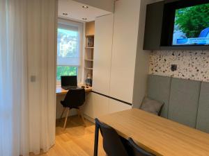 a room with a table and a desk with a computer at LUXURIOUS ONE BEDROOM STUDIO IN TOP CENTER in Blagoevgrad
