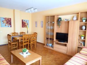 a living room with a table and a dining room at PISO AMPLIO A 100 M DE LA PLAYA in Foz