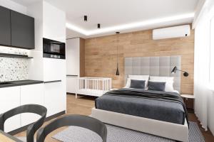 a bedroom with a bed and a table and chairs at LUXURIOUS ONE BEDROOM STUDIO IN TOP CENTER in Blagoevgrad