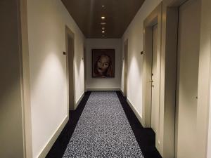 a hallway with a painting of a woman on the wall at The Gold Bank in Prague