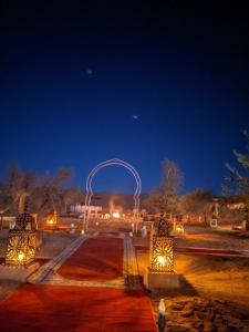 a sculpture of an arch in a park at night at Sahara Majestic Luxury Camp in Merzouga