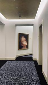 a room with a painting of a woman on the wall at The Gold Bank in Prague