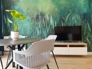 Televízia a/alebo spoločenská miestnosť v ubytovaní Apartament Triventi 88 z Widokiem na Śnieżkę - 5D Apartamenty