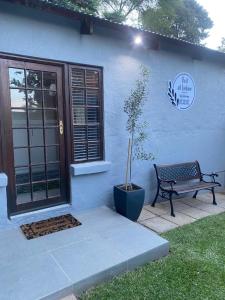 a bench sitting in front of a house at Rest at Lieben in Bloemfontein