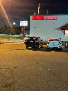 two cars parked in front of a gas station at The Wayne Inn in Wayne