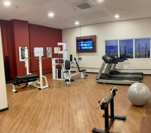 a gym with treadmills and exercise equipment in a room at Lummina Mogi in Mogi Guaçu