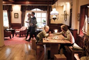 a group of people playing a game at a table at Hotel Strandhof in Baltrum