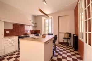 a kitchen with a counter and a checkered floor at LES CORDERIES in Les Sables-d'Olonne