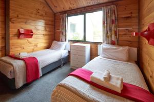 a bedroom with two beds in a wooden cabin at Retro Inn 1 - Lake Tekapo in Lake Tekapo