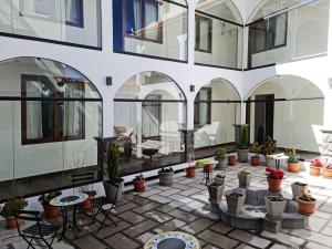 a courtyard with potted plants in a building at ATOJJA CHUCUITO HOTEL in Puno