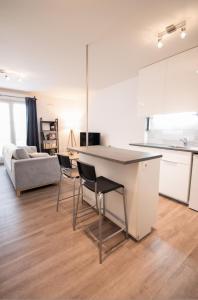 een keuken en een woonkamer met een tafel en stoelen bij Joli studio tout confort à 2 pas de la gare Poissy in Poissy