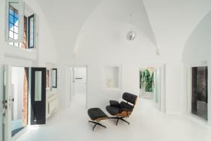 two chairs in a room with white walls at Sophia Privilege in Oia