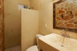 a bathroom with a toilet and a sink at My Sisters House - Female only in Sayulita +28 photos