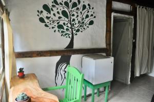 een kamer met een tafel en een boom aan de muur bij Viejamar B&B in Puerto López