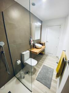 a bathroom with a toilet and a sink at Apartamento de obra nueva cerca de la playa by Top Stay in El Médano