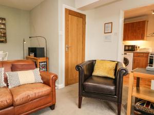 a living room with a couch and a chair at 3 Vale View in Hawkshead