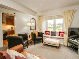 a living room filled with furniture and a tv at 3 Vale View in Hawkshead