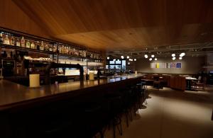 a bar with a long counter in a restaurant at THE KNOT TOKYO Shinjuku in Tokyo