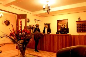 a man standing at a cash register with a woman at Hotel Danibaan in Oaxaca City
