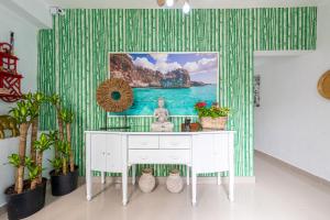 a room with a white desk with a statue on it at Bamboo Hoouse in Santo Domingo
