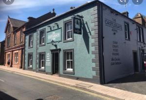 a blue building on the side of a street at The castlegate arms in Penrith