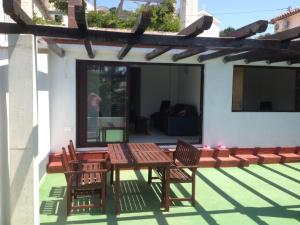 a patio with a table and chairs on a house at Rooms Zdravko in Stara Novalja
