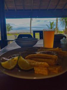 Un plato de comida en una mesa con un vaso de jugo de naranja. en Posada Don Aí, en El Valle