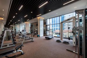 a gym with cardio equipment in a building at The Five Residences Hanoi in Hanoi