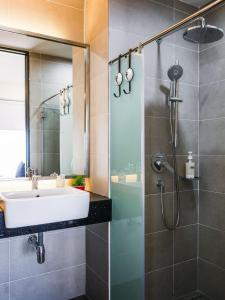 a bathroom with a sink and a shower at Tropicana 218 Macalister Studio with Seaview in George Town