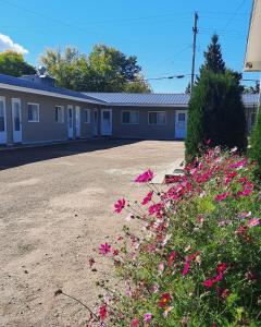 a building with pink flowers in front of it at Vista Motel in Vegreville