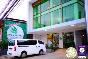 a white van parked in front of a building at Vivien's Hotel in Mactan