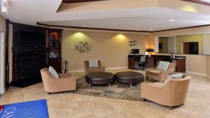 a lobby with a waiting room with chairs and a table at Candlewood Suites Athens by IHG in Athens