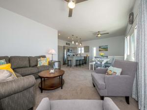 a living room with a couch and chairs and a table at Sea Latch Inn in York Beach