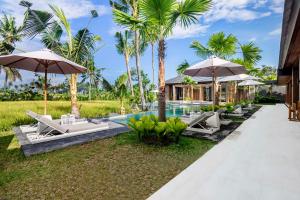 an image of a villa with a swimming pool and umbrellas at Villa Florentine by BaliSuperHost in Ubud