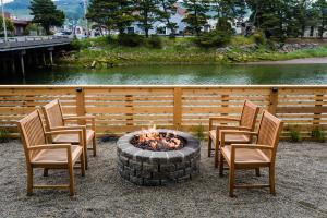a group of chairs sitting around a fire pit at River Inn at Seaside in Seaside