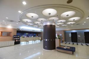 a lobby with a large chandelier in a store at Smile Hotel Tokushima in Tokushima