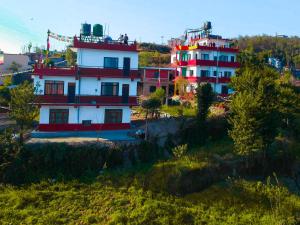 a building on top of a hill with trees at Tashidelek Guest Lodge & House in Dhulikhel