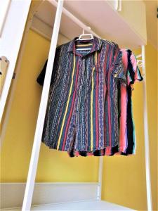 a shirt hanging on a shelf in a room at Cozy one bedroom apartment with spacious terrace. Pool and garden view in Costa Del Silencio +12 photos