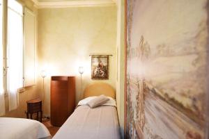 Posteľ alebo postele v izbe v ubytovaní Italian Experience-Suite Medici
