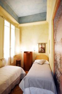 Posteľ alebo postele v izbe v ubytovaní Italian Experience-Suite Medici