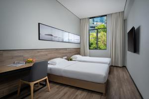 Voodi või voodid majutusasutuse Unijoy Cityinn OCT Loft Shenzhen有集城市客栈创意园店 toas