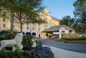 a building with a lion statue in front of a building at Washington Duke Inn & Golf Club in Durham