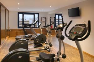 a gym with several cardio machines in a room at Holiday Inn Stuttgart, an IHG Hotel in Stuttgart