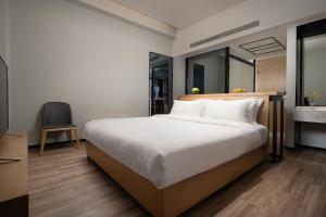 Voodi või voodid majutusasutuse Unijoy Cityinn OCT Loft Shenzhen有集城市客栈创意园店 toas