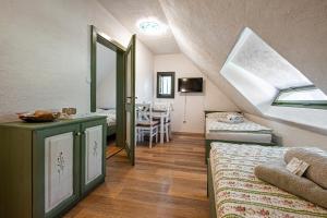 a attic room with two beds and a window at Penzion Betlém in Hlinsko