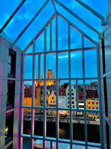 a view of a city skyline through a window at Elite Apartments Granaria The View in Gdańsk