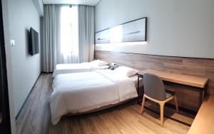 Voodi või voodid majutusasutuse Unijoy Cityinn OCT Loft Shenzhen有集城市客栈创意园店 toas