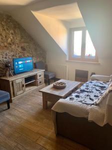 a bedroom with a bed and a tv in a attic at Annecy Sainte Claire proche Gare-Lac Duplex 4e étage pour 4ou6 personnes climatisation in Annecy