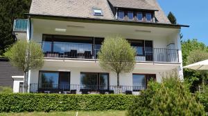 a large white house with a balcony at Landhaus Mettenberg in Niedersalwey